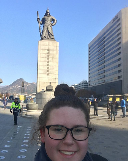 Kelleogg with the statue of Admiral Yi Sun-sin in Seoul, South Korea.