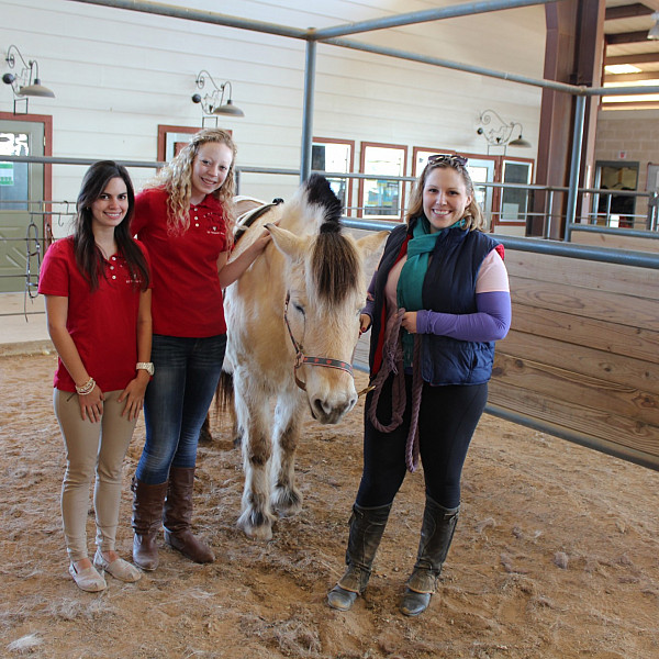 Celia Caraccioli (left) and Meredith Rollins stand with Emilie Ross (right), an applied behavior analyst who works at R.O.C.K., and Shandy, one of the ponies the center uses to provide equine-assisted therapy to children. (Photo by Elizabeth Stewart)