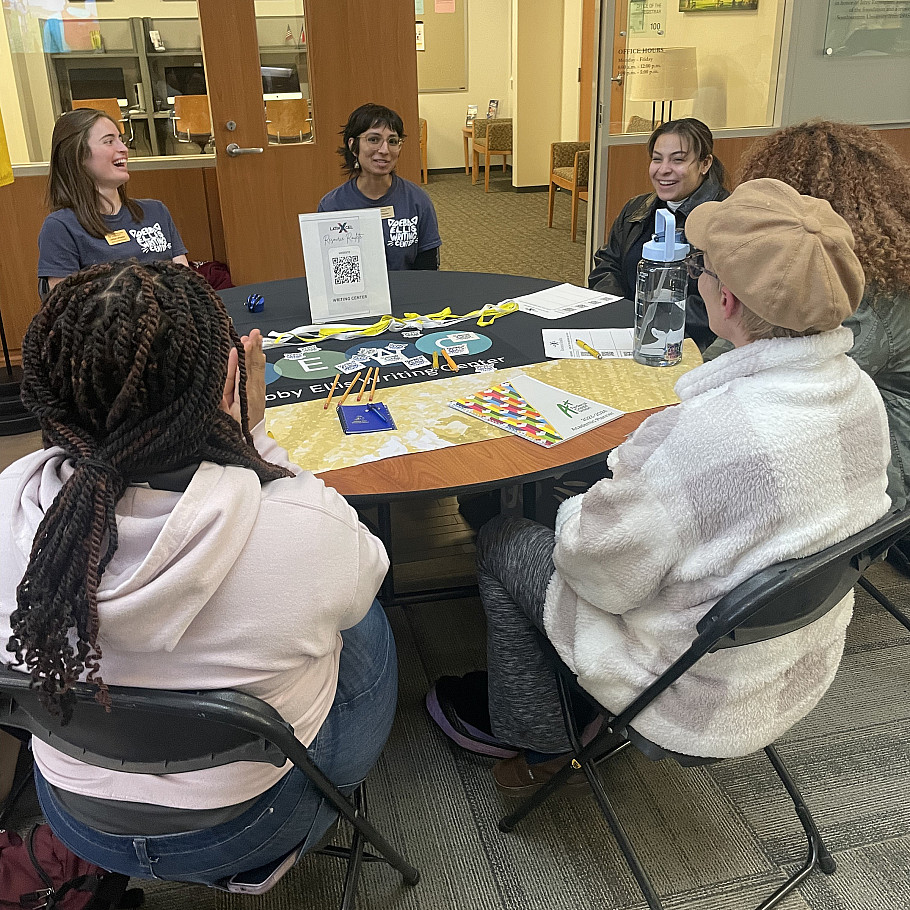 LatinXcel students engaging with representatives from the Debby Ellis Writing Center at the LatinXcel Resource Roulette in January 2024.